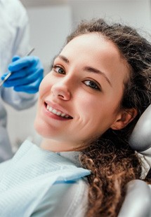 patient smiling while in dental chair