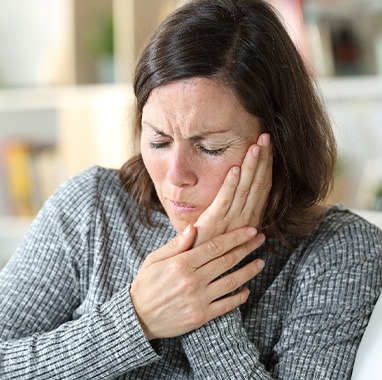 A woman experiencing oral pain