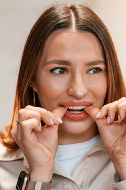 Patient putting on clear aligner