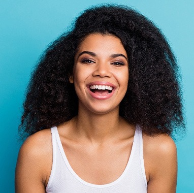 Woman in white tank top smiling