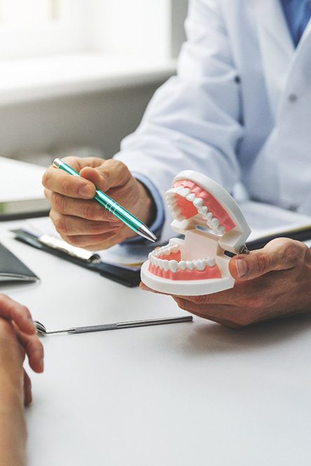 dentist explaining dentures in North Attleboro