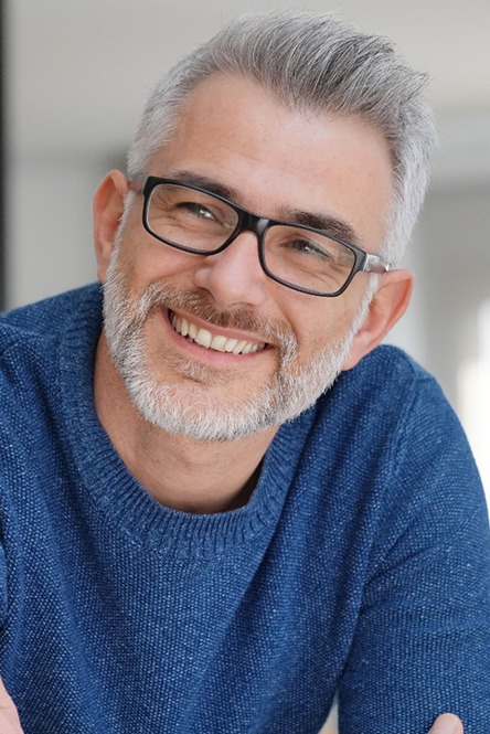 man smiling after getting dentures in North Attleboro