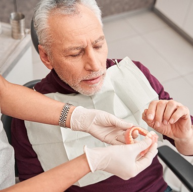 Man with dentures at the dentist