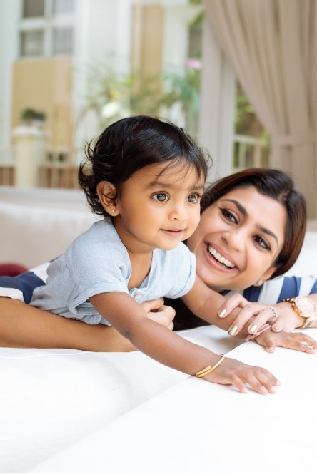 Mother and child smiling together after family dentistry