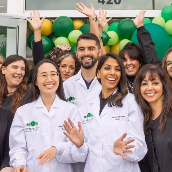 Attleboro Dental Group team members smiling and celebrating