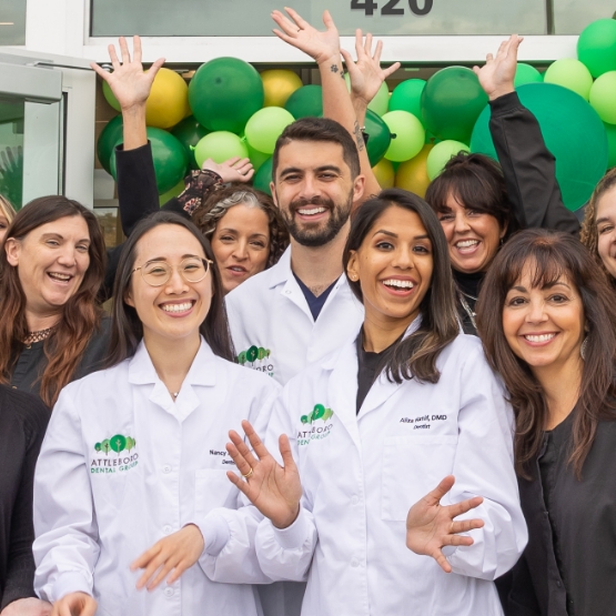 Attleboro Dental Group team members smiling and celebrating