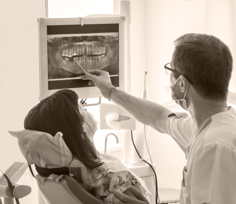 Dentist and dental patient looking at digital dental x rays