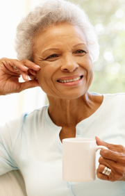 Older woman smiling while sitting on couch