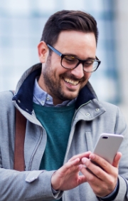 Man checking his cell phone outdoors