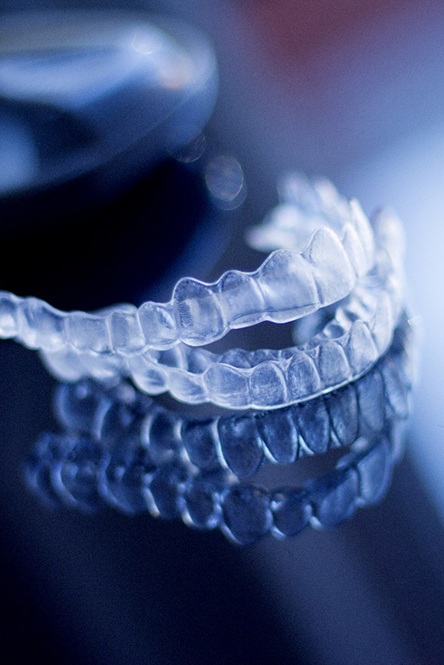 Invisalign aligners on a luxurious background