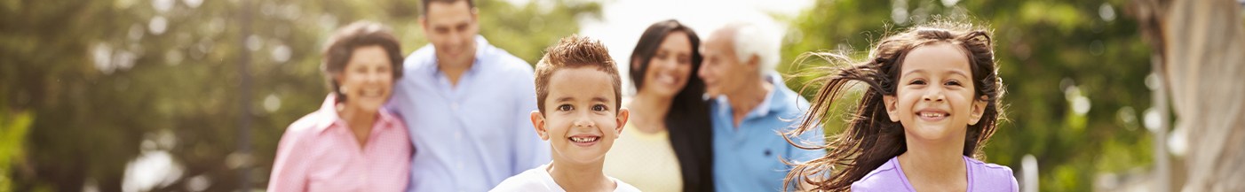 smiling family outdoors after visiting their dentist near Plainville