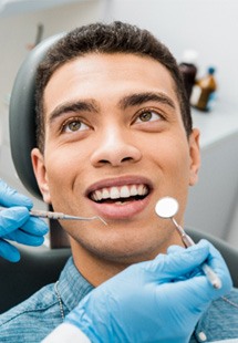 patient smiling while looking at dentist 