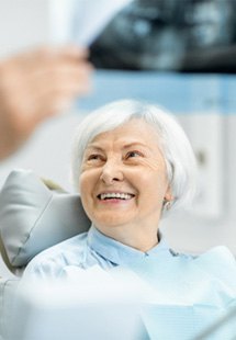 patient smiling while looking at dentist 