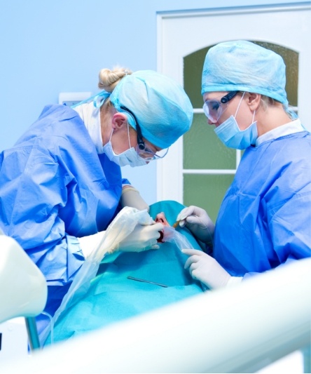 Dentist and dental team member treating patient