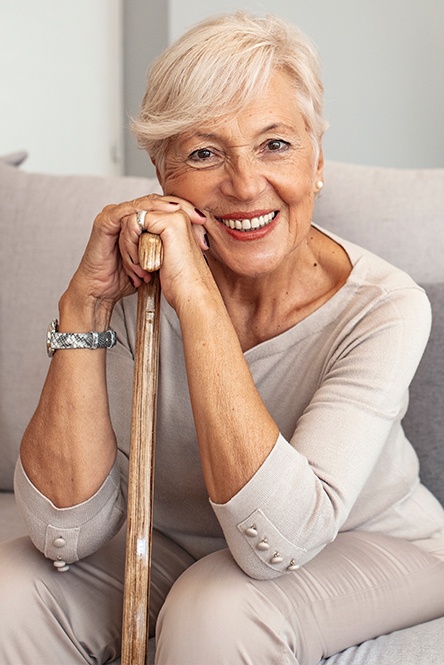 Woman with dentures sharing flawless smile