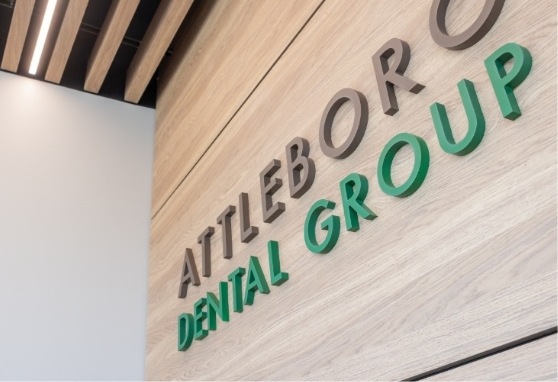 Attleboro Dental Group sign on a wall
