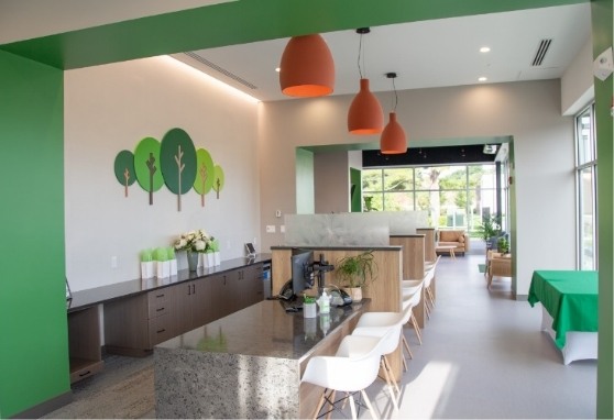 Orange light fixtures hanging from the ceiling in waiting area
