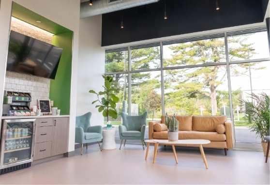 Waiting area with cozy chairs and a loveseat and a refreshment station