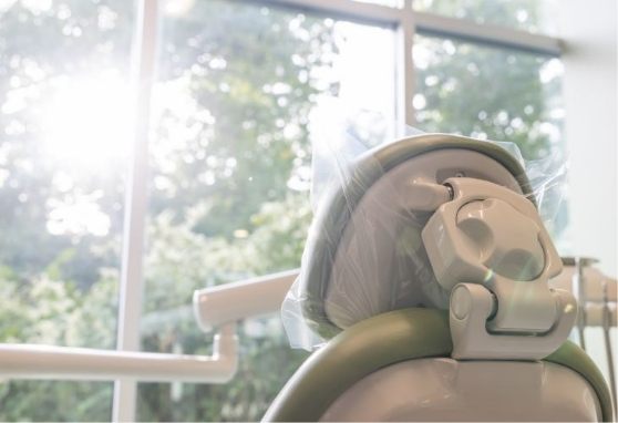 Back of a dental treatment chair covered in plastic wrap