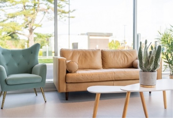 Light brown leather loveseat in the waiting area