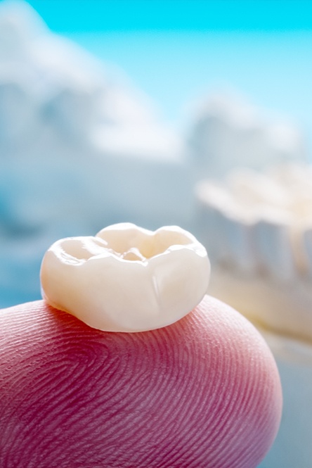 Dental crown on fingertip