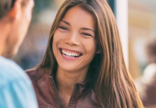 Woman sharing smile after replacing missing teeth