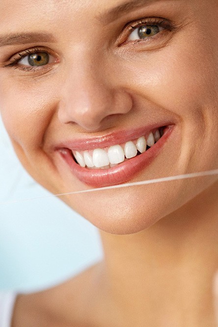 closeup of woman flossing