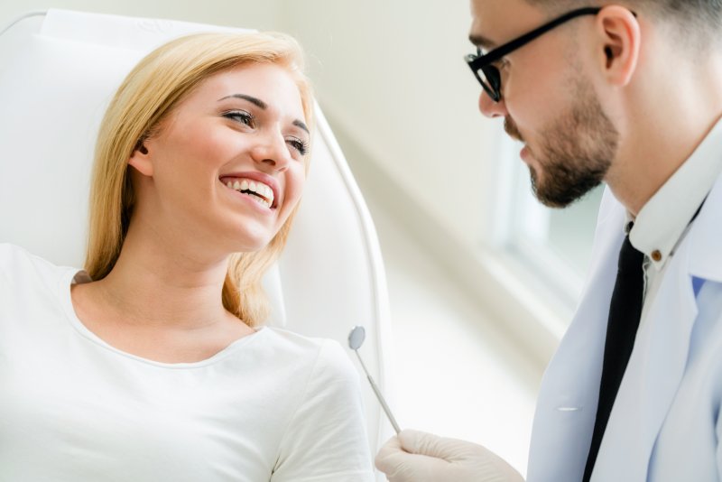 A cosmetic dentist talking with a patient