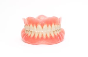 Set of new dentures on a white background