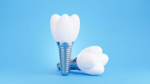 Two dental implants on a light blue background