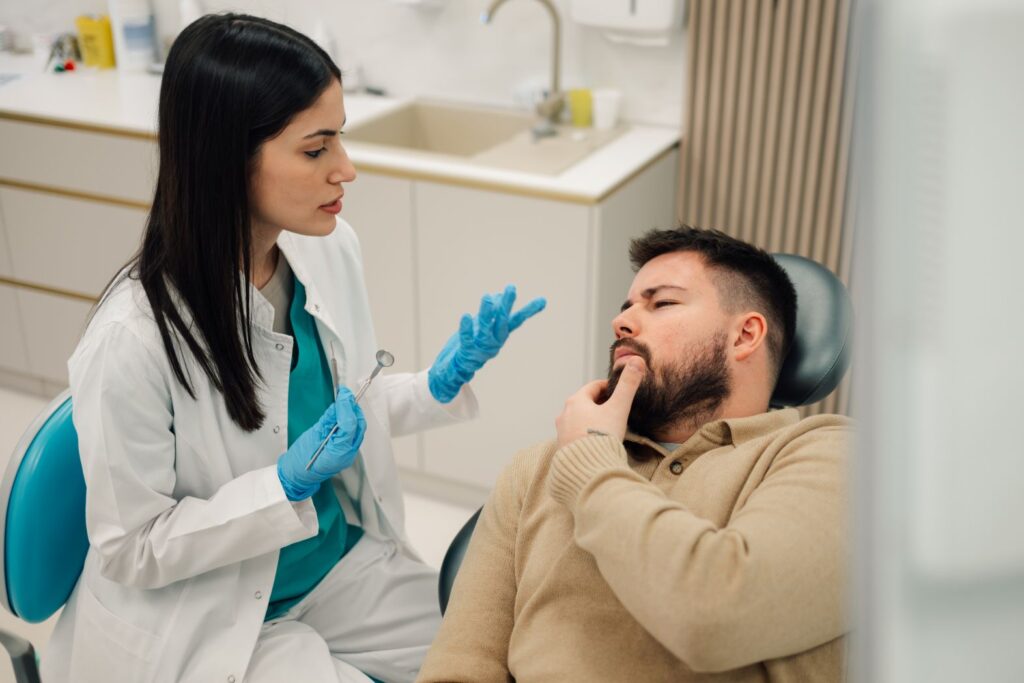 A man discussing gum disease treatment with his dentist