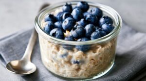 a cup of oatmeal and blueberries